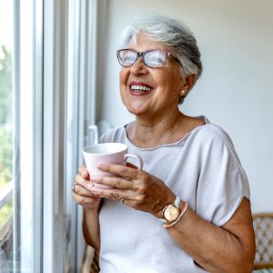 Senior,Woman,Drinking,A,Beverage,At,Home.,Charming,Elderly,Woman
